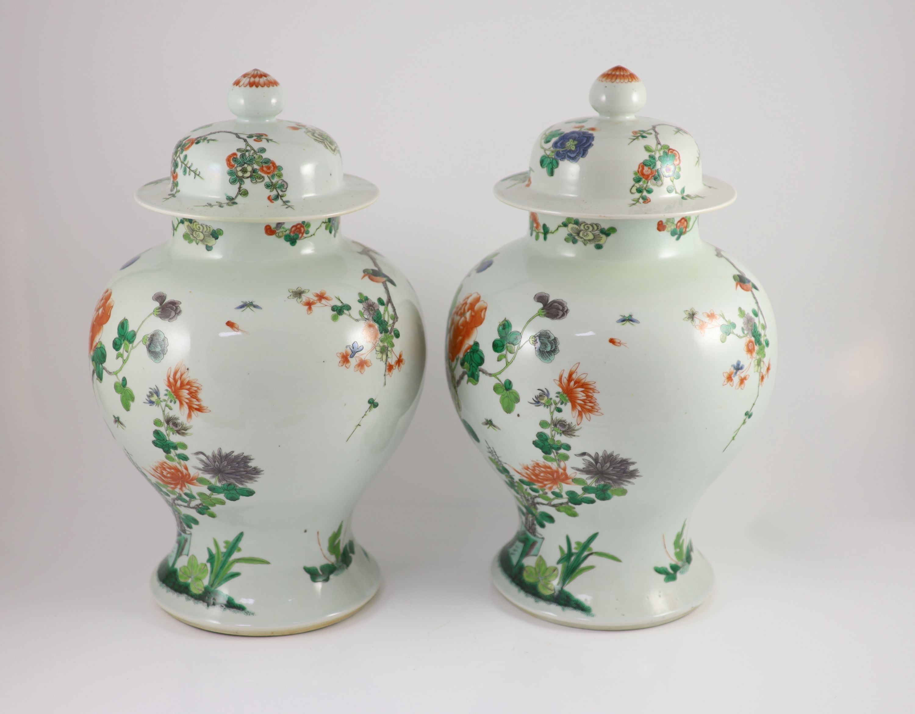 A pair of large Chinese famille verte jars and covers, late 19th century, 45cm high, restorations